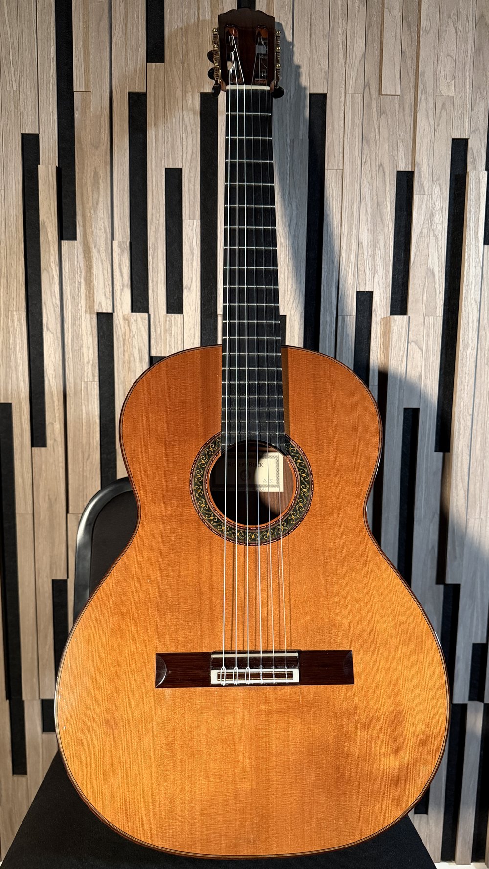 Robert Ruck № 1061 standing against a wall: warm cedar top, colored mosaic rosette, rosewood bridge