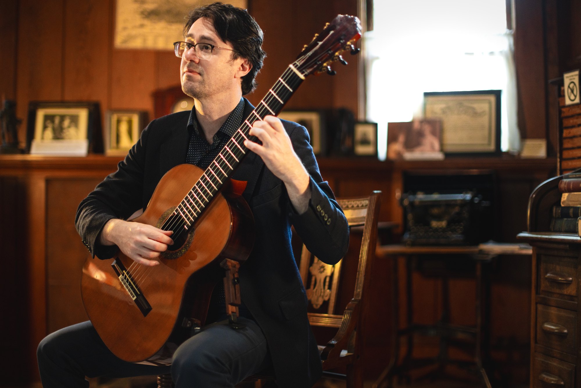 Yuri Liberzon playing his guitar, mid-performance