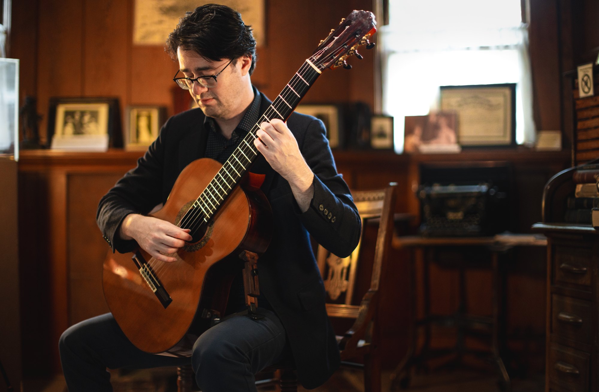 Yuri Liberzon playing his guitar, mid-performance