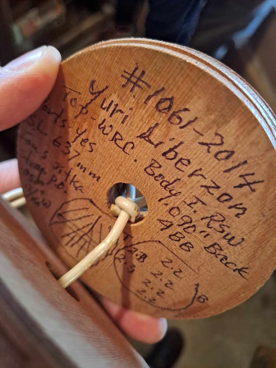 A wooden disc cut from a guitar soundhole, handwritten in ink: #1061-2014, Yuri Liberzon, Top WRC, S.L. 637mm